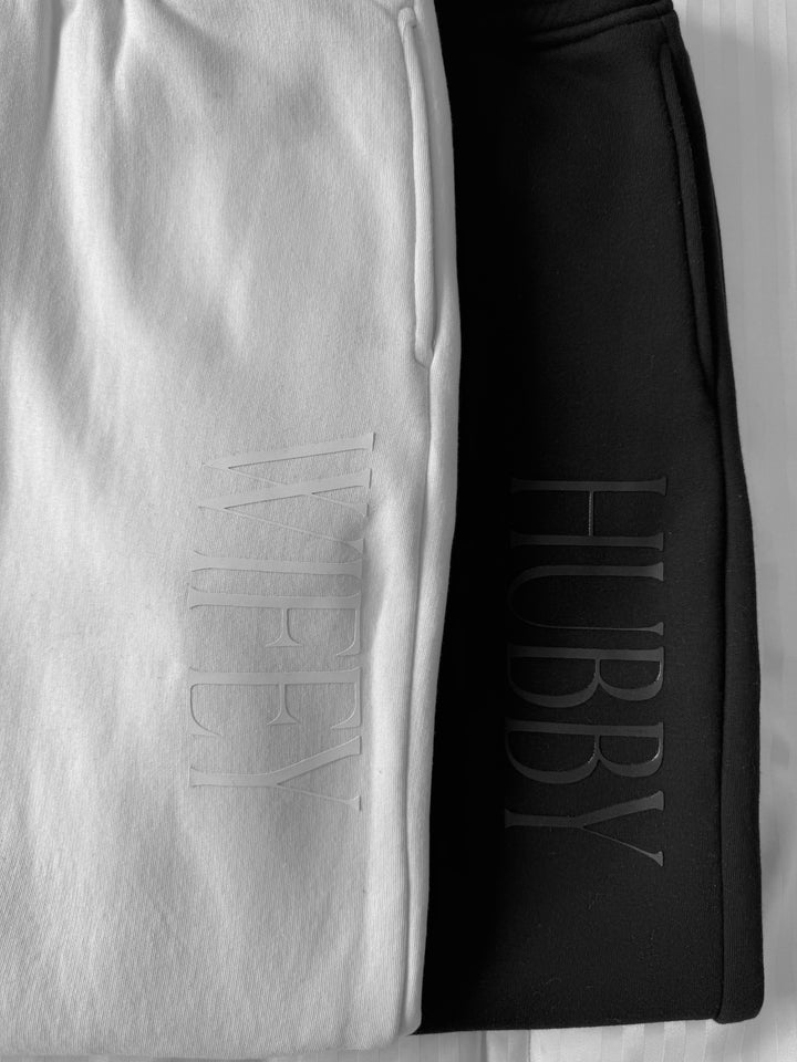 A close up of a white on white wifey and black on black hubby monochrome luxury sweatpants and joggers gift for newly weds and honeymooners by vanity couture